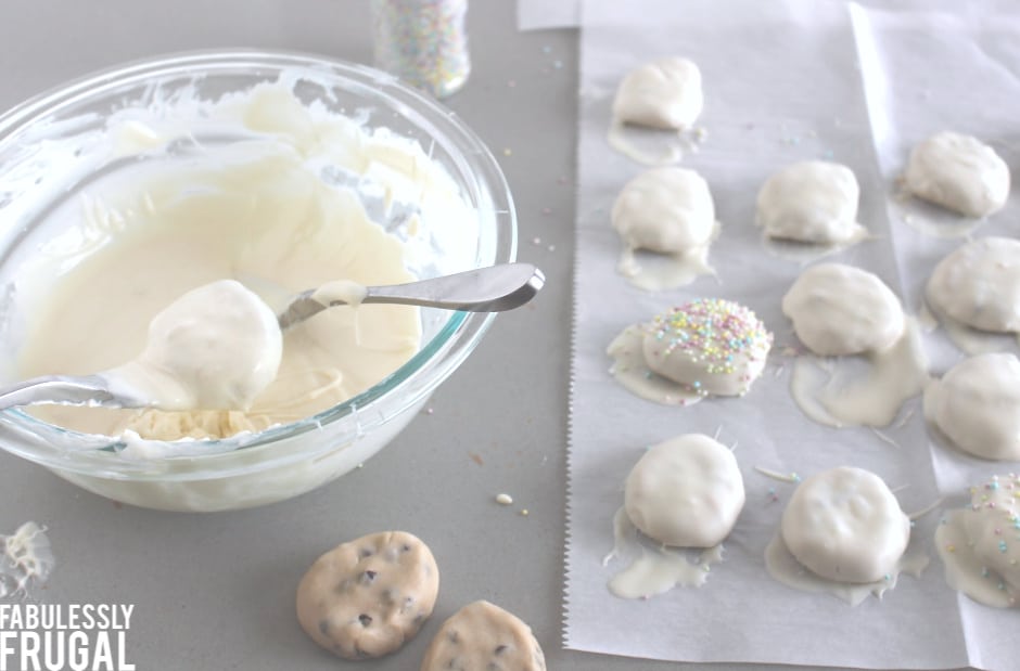 Dipping egg free cookie dough truffle eggs in white chocolate