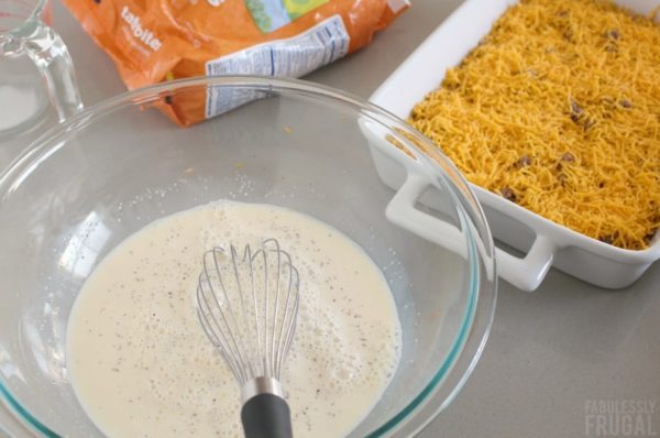 tater tot breakfast casserole before baking in a casserole dish