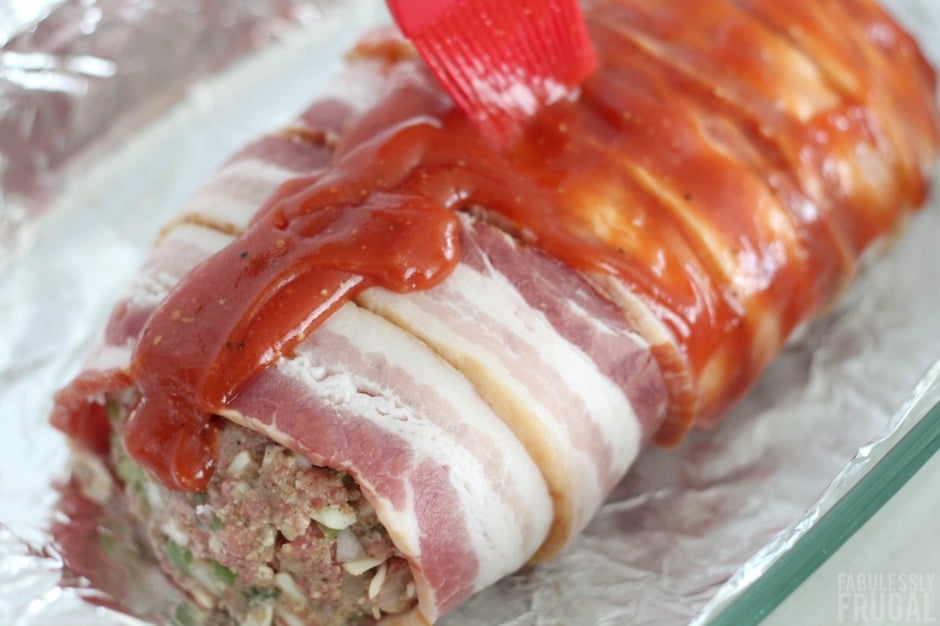 Saucing the keto bacon wrapped meatloaf