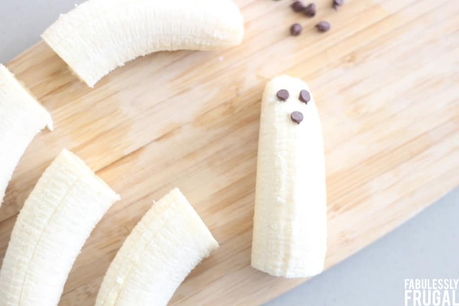 Bananas on a cutting board with chocolate chips