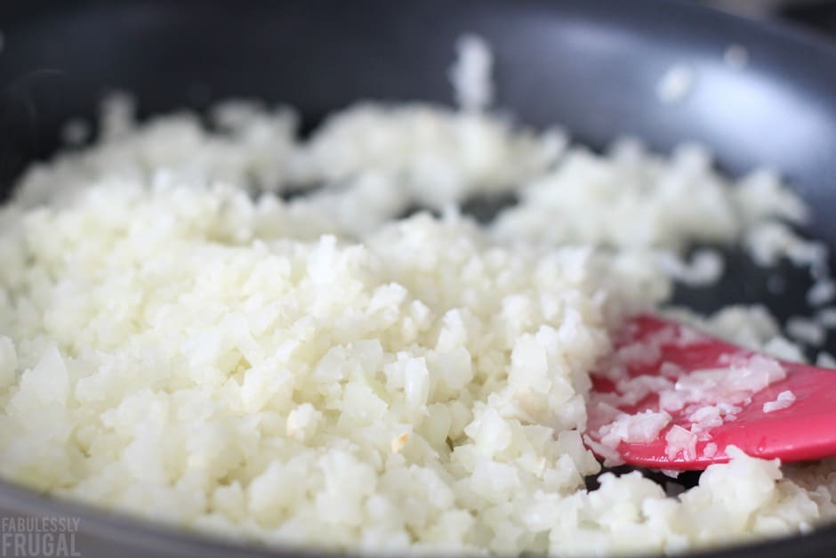 Cauliflower rice cooking in a skillet