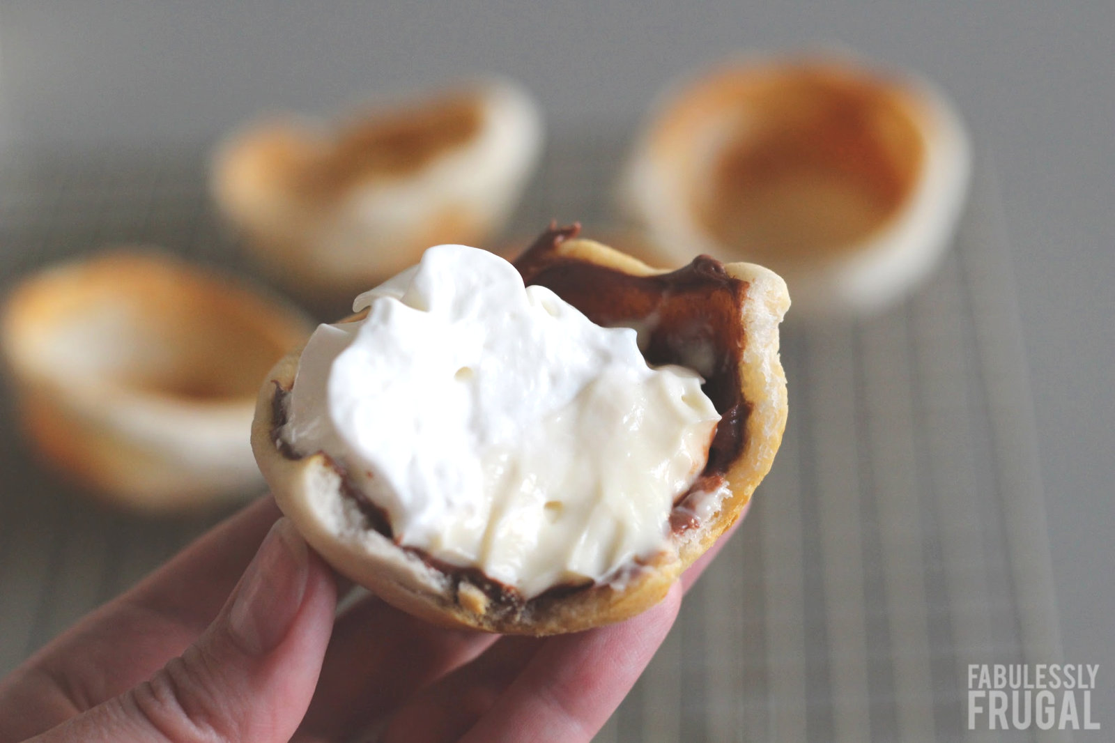 Oven baked eclair biscuit cup with chocolate pudding and whipped cream