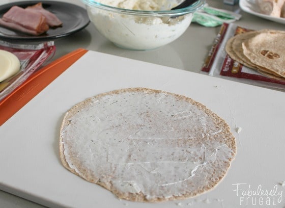 cream cheese spread on tortilla for tortilla pinwheel