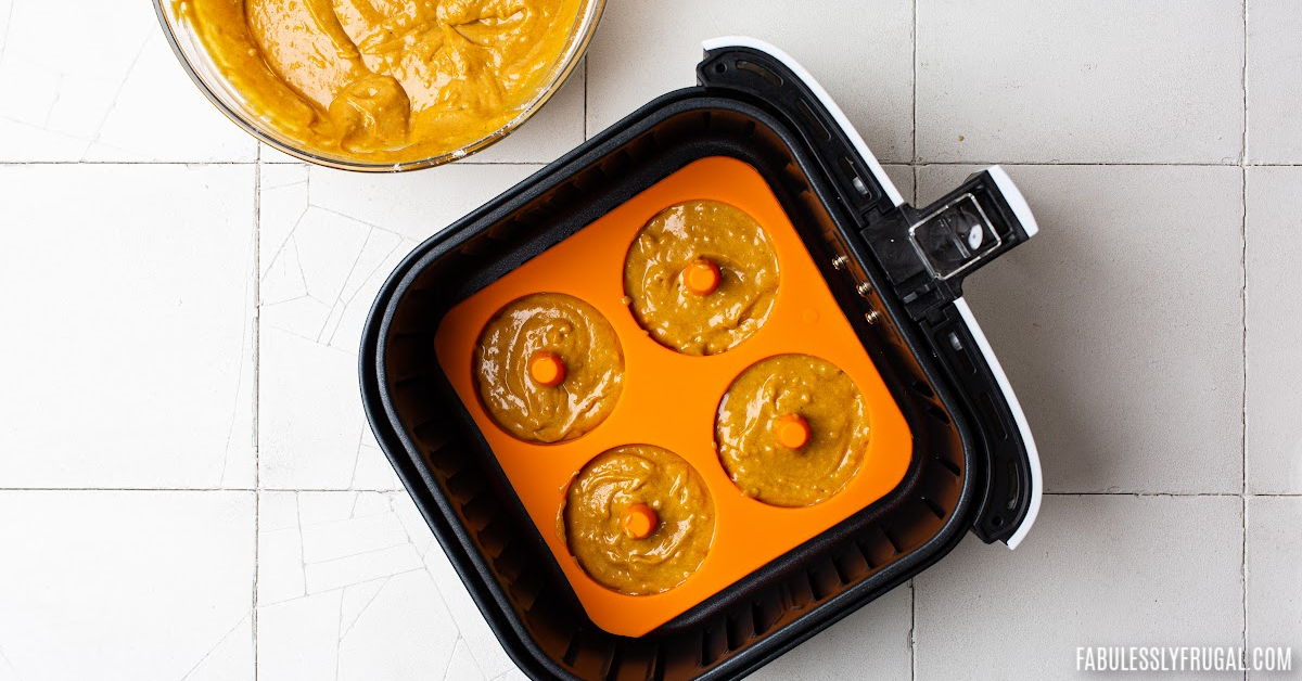 Pumpkin donut batter in silicone baking pan in the air fryer