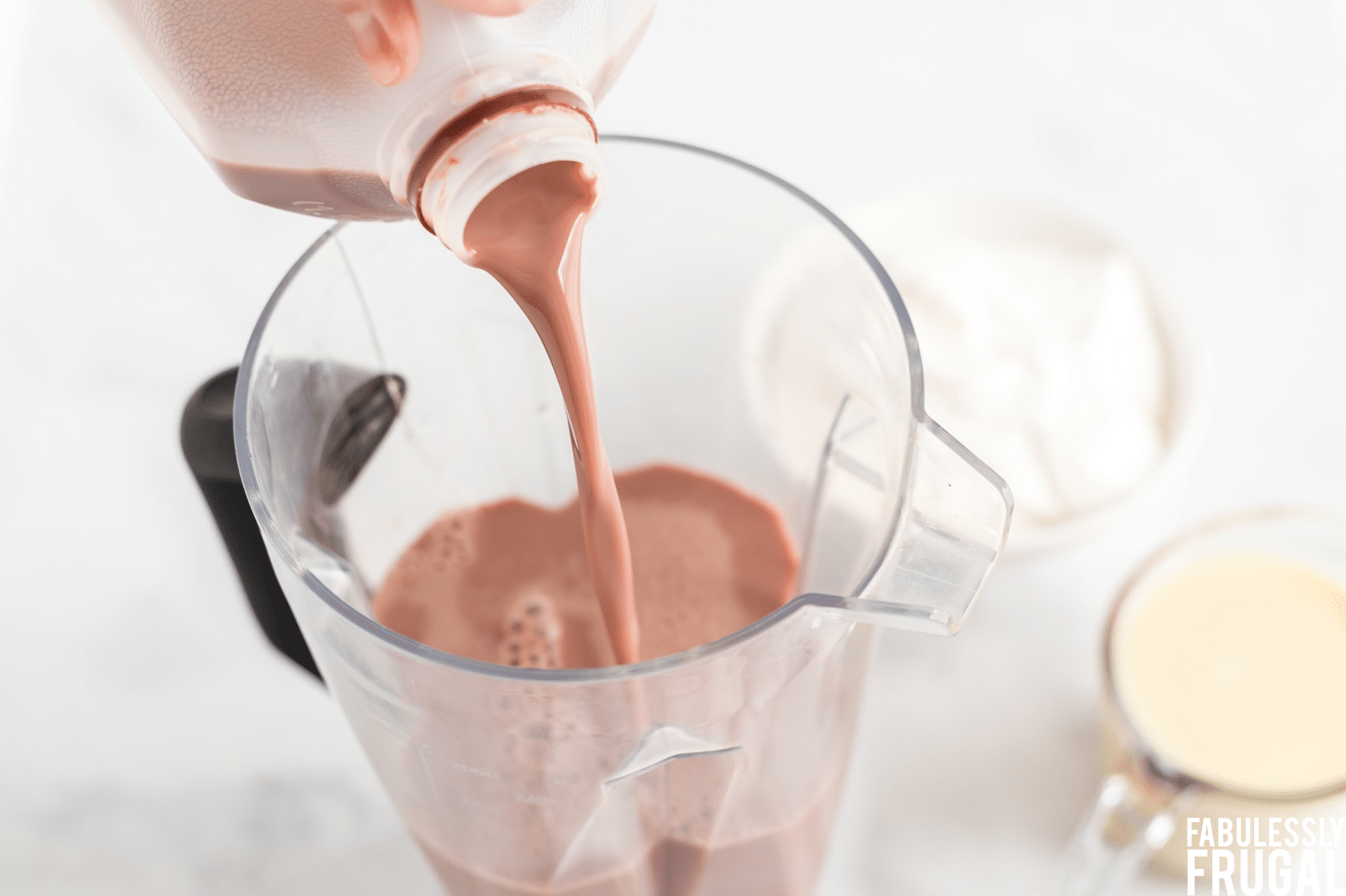 Pouring chocolate milk in blender