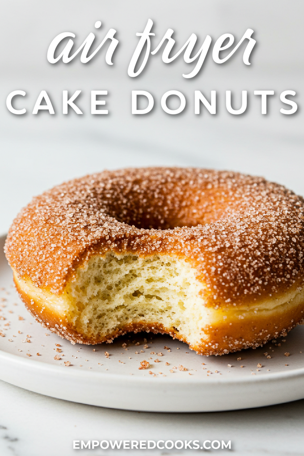 a bite out of a cinnamon sugar cake donut