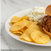 dinner plate with sloppy joes, chips, and coleslaw