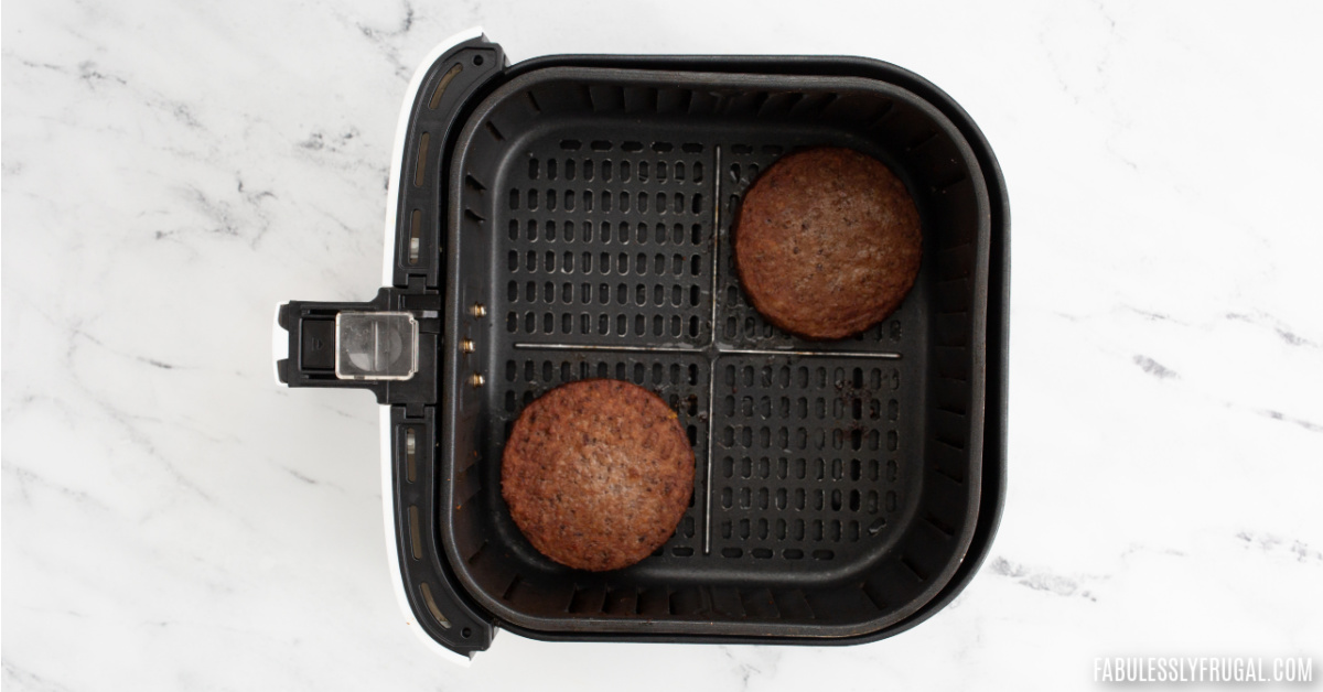 cooked impossible burger patties in the air fryer basket