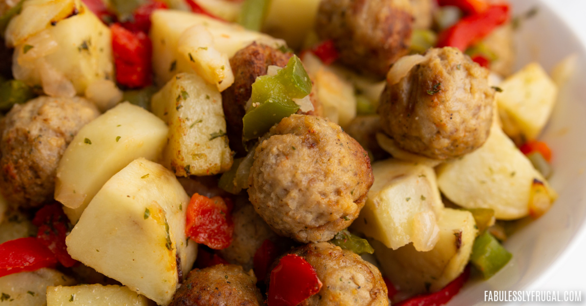close-up image of meatballs, potatoes, bell peppers, and onions in a serving dish