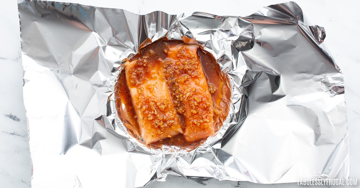 asian salmon in tin foil covered in sauce
