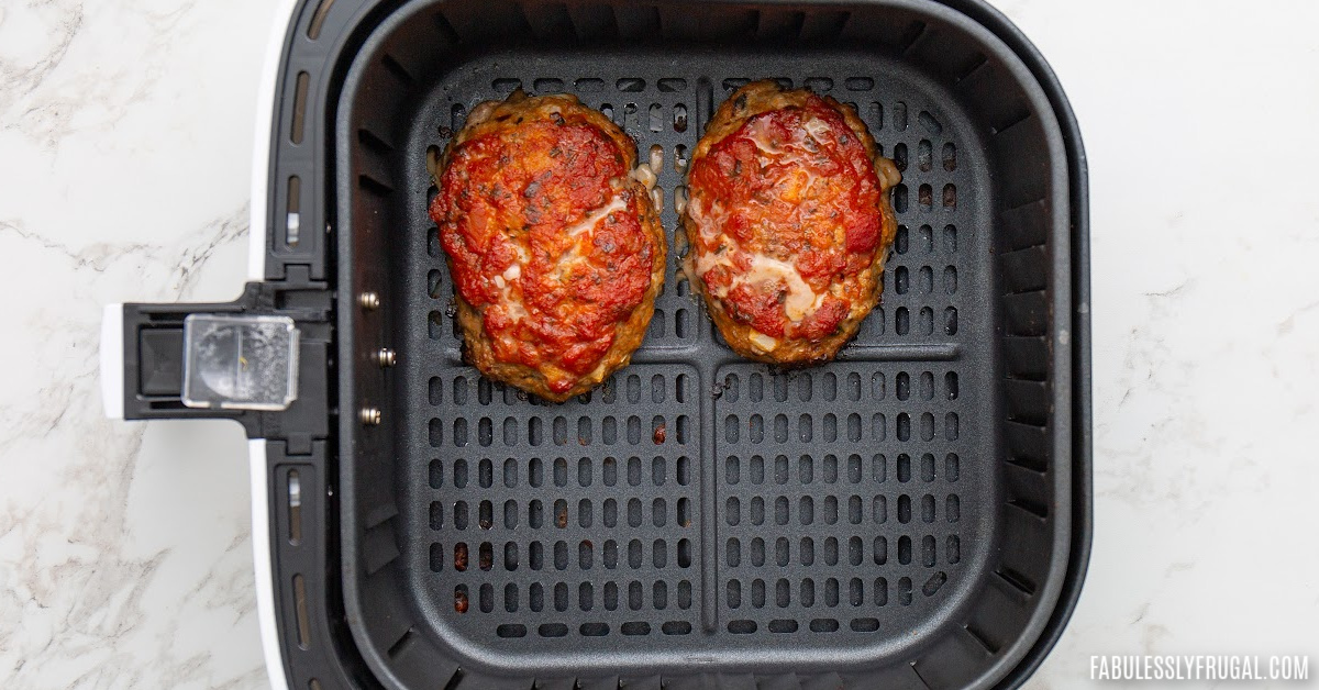 cooked meatloaf patties in air fryer basket