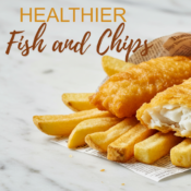 air fried fish and chips wrapped in newspaper on a white marble background