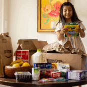 little girl opening a box of amazon same day delivery groceries