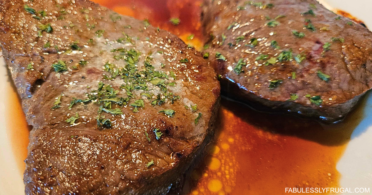 air fryer top sirloin filet cooked and sliced on plate with vegetables